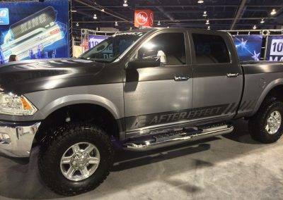 Large grey and black truck with custom vinyl applied to the body