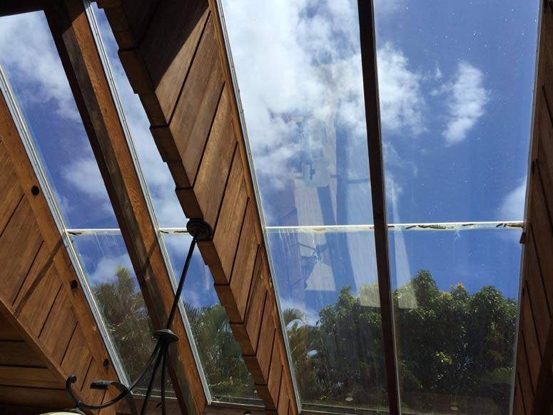 Large tinted skylight windows photographed from indoors